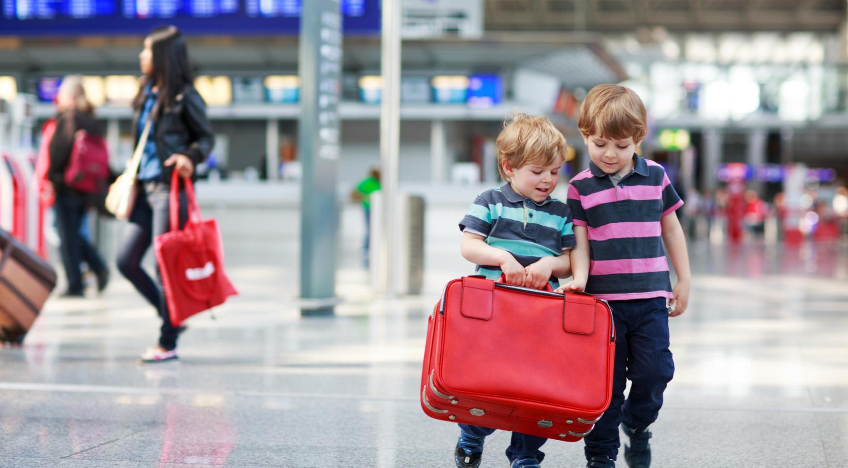 Travelers picking up suitcase
